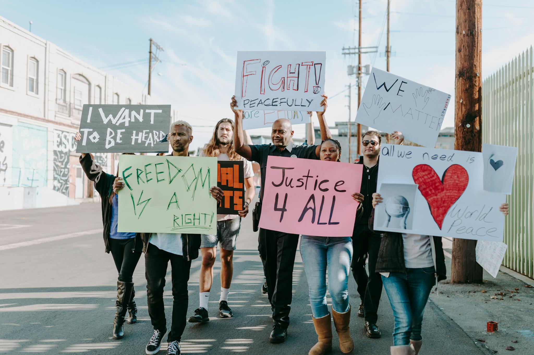 Group of activists hold signs advocating for justice and equality during a street protest.