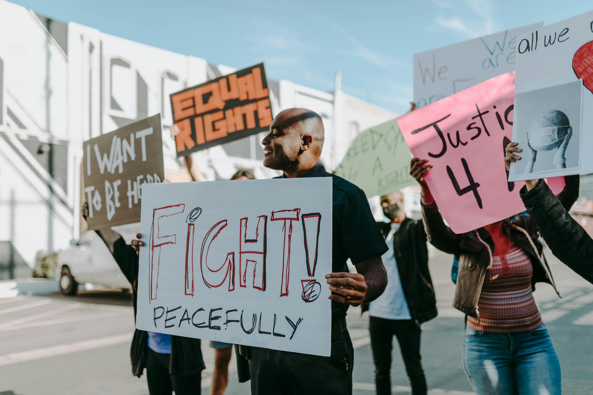 Protesters advocating for equal rights and justice with peaceful protest signs.